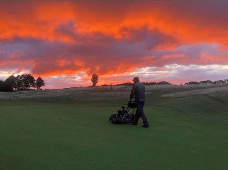 Image of Connor Lang on golf course at sunset