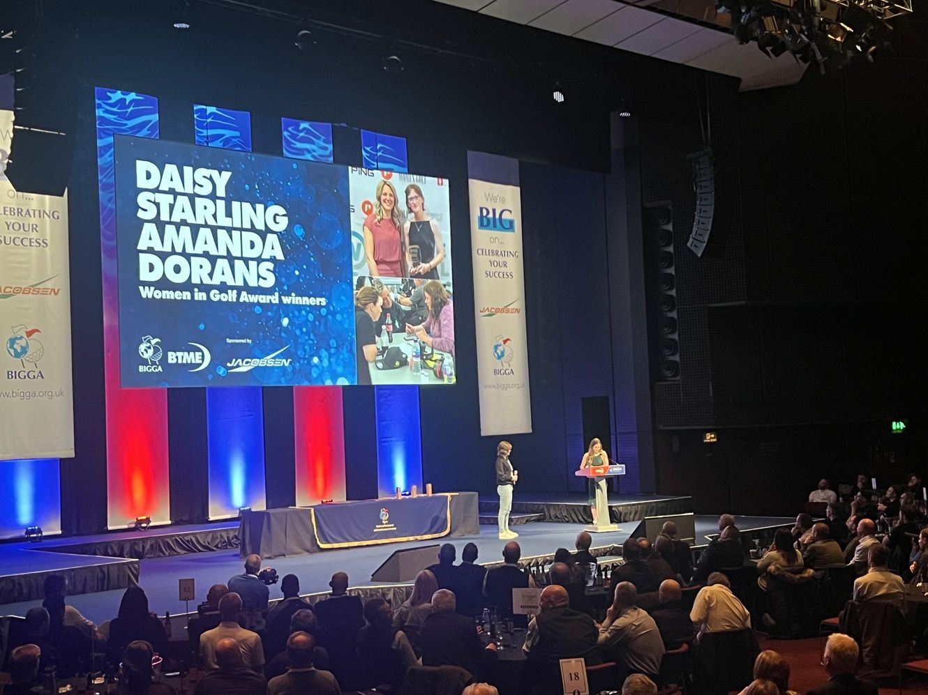 Student on stage collecting award