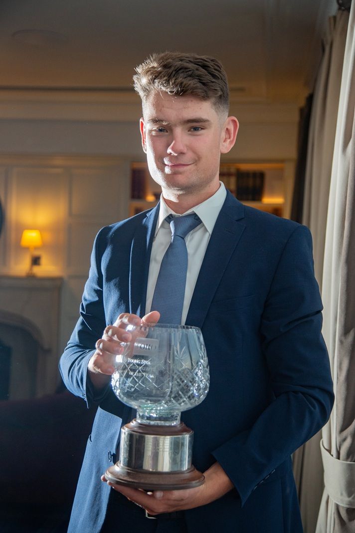 Student holding award