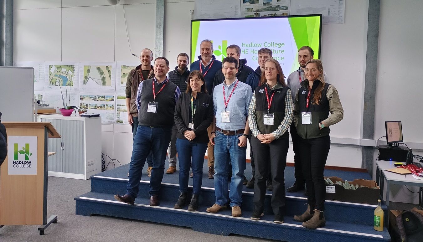 Group of people stood in front of screen